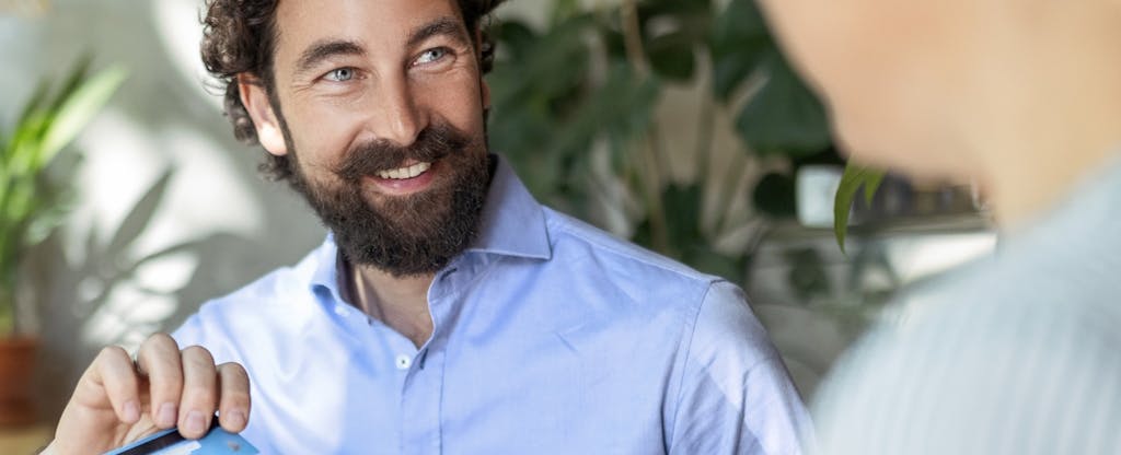 chase-freedom-unlimited-new-card-value Businessman using credit card for contactless payment in cafe.