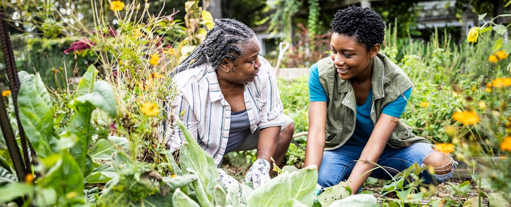 best-mortgage-refinance-lenders Two people smiling at each other as they chat and work together in their garden